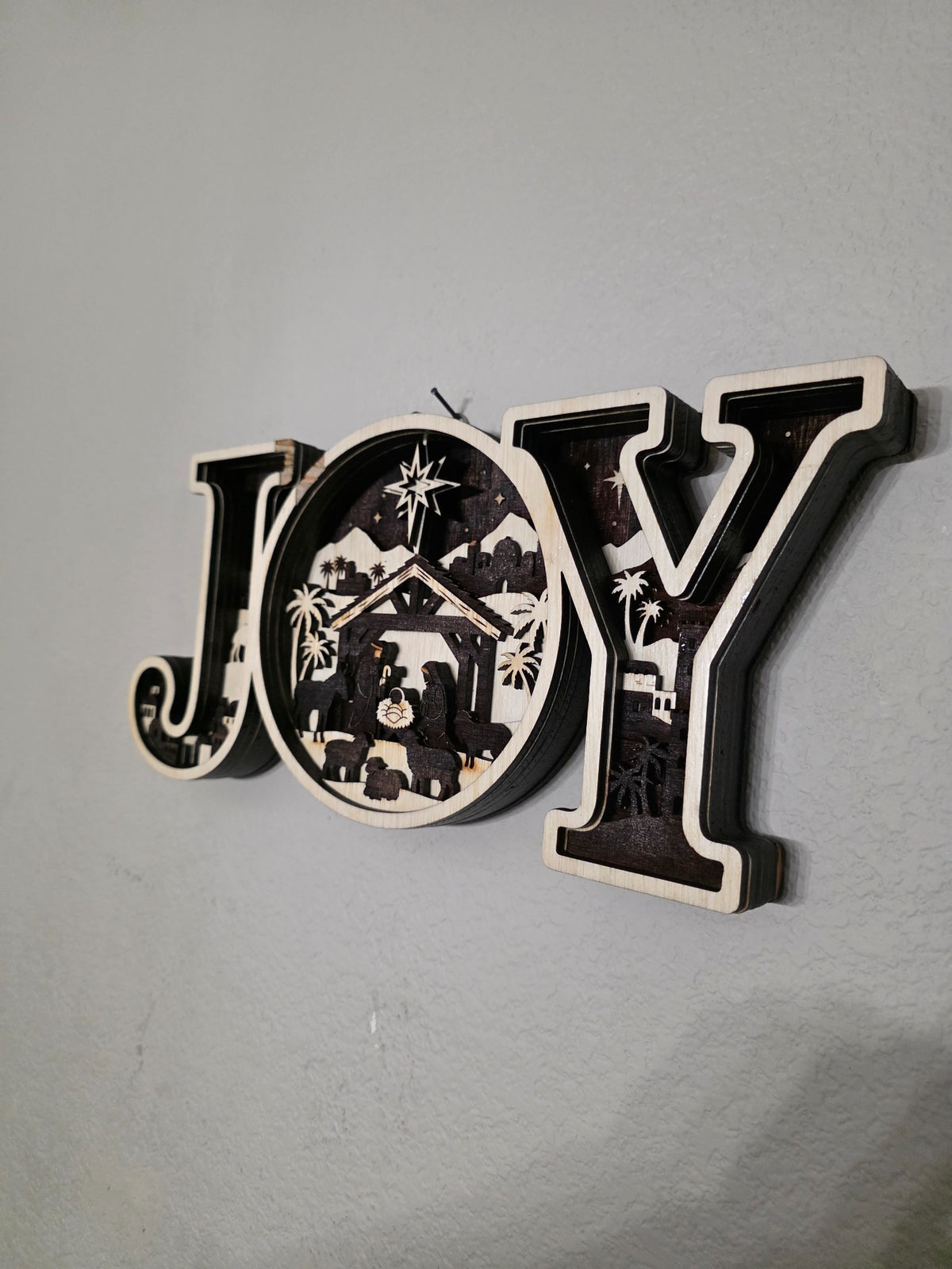 Right side angle showing depth of JOY nativity layered wood wall art