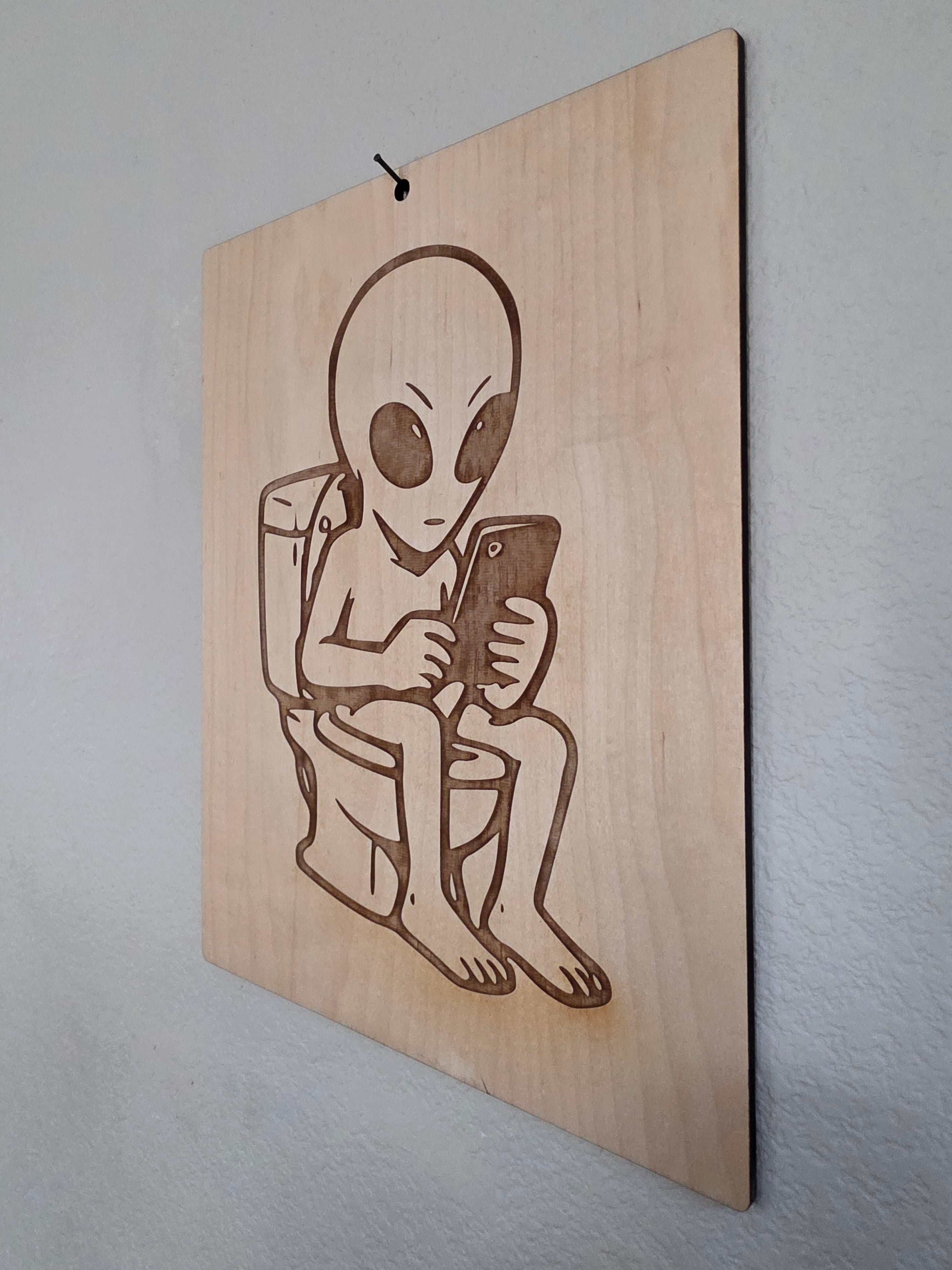 Alien on the Toilet – 11" x 17" Engraved Maple Bathroom Wall Art