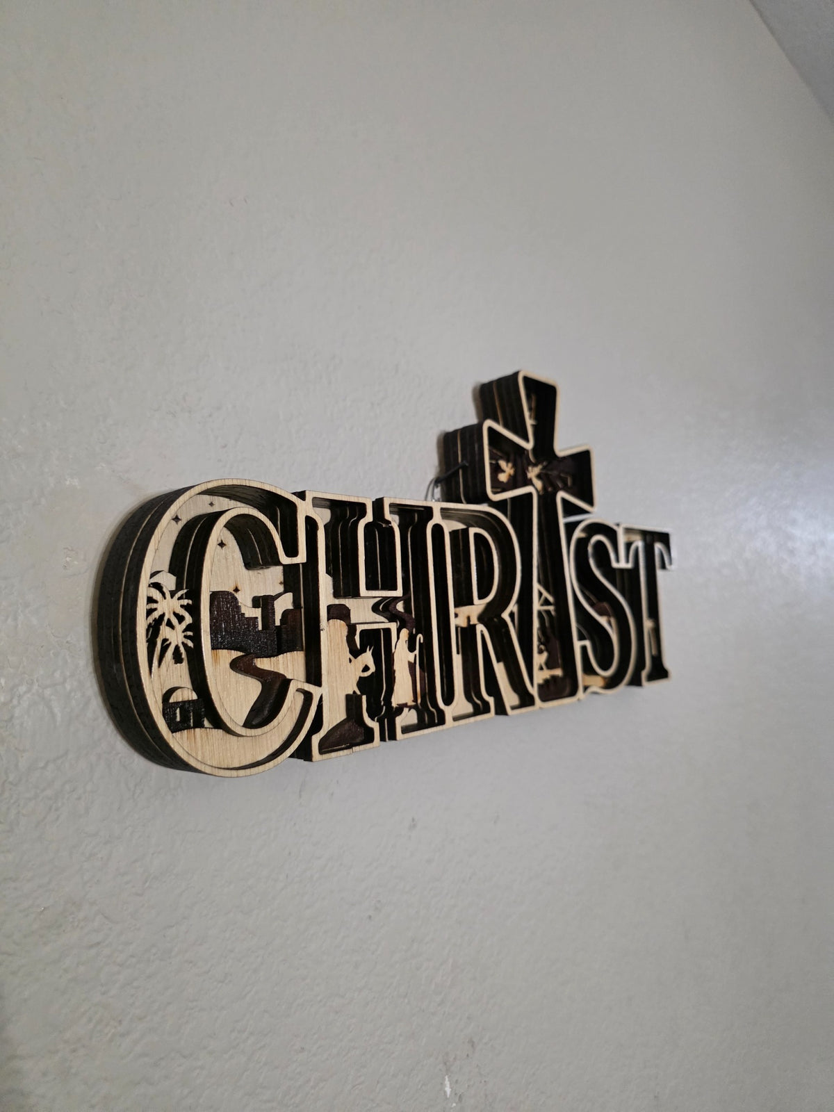 Left angle of CHRIST nativity layered wood wall art showing layered depth