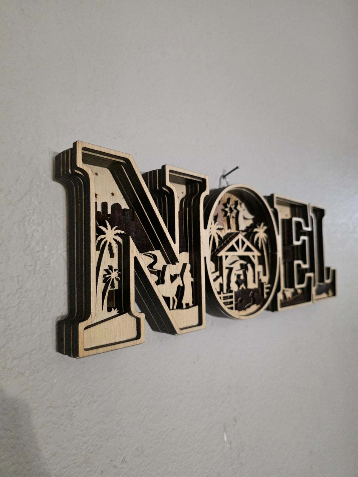 Side angle of layered NOEL nativity wood wall art