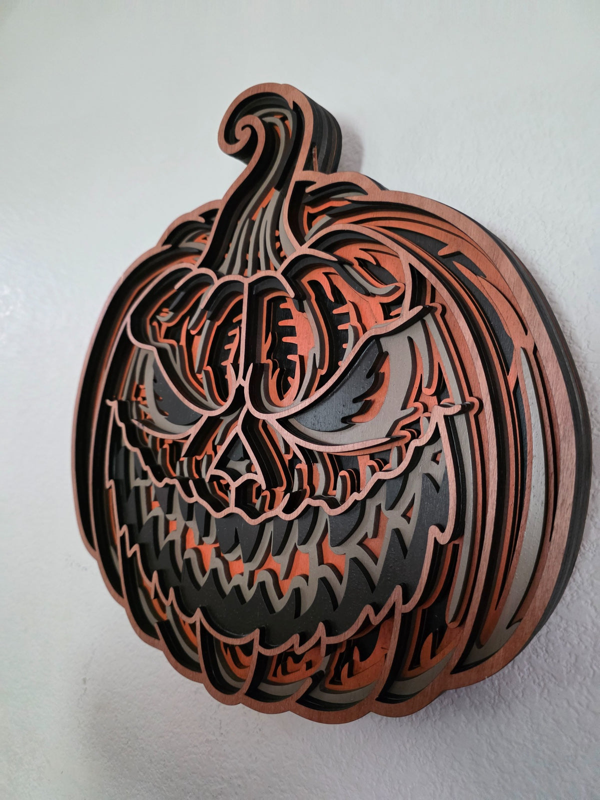 Side view of sinister layered wood jack-o-lantern Halloween wall art